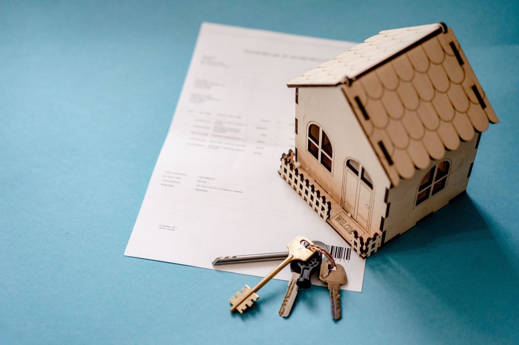 Conceptual real estate image featuring icons and symbols associated with homeownership, property, and home loans.